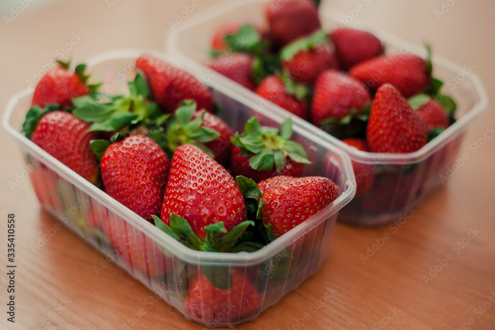 Red ripe fresh strawberry packed in plastic boxes at wholesale storage market for transportation and shipping export and import. Nutritious healthy strawberry diet food. Red ripe fresh strawberry packed in plastic boxes at wholesale storage market for transportation and shipping export and import. Nutritious healthy strawberry diet food.