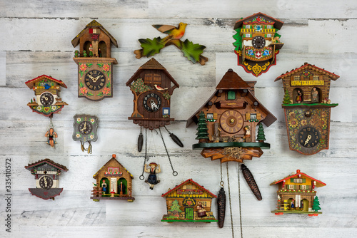 Vintage cuckoo clock collection on white background photo