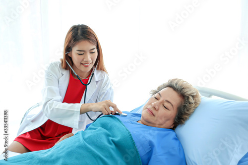 Asian doctor having checkup for a senior patient taken by soft focus technique