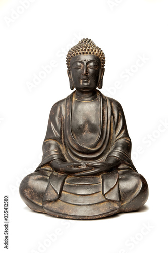 A small replica statue of The Buddha isolated on white