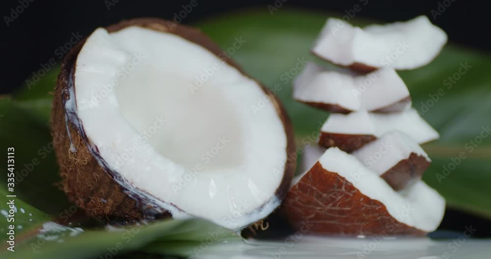 Coconut milk flows to the pieces of coconut with leaves.
