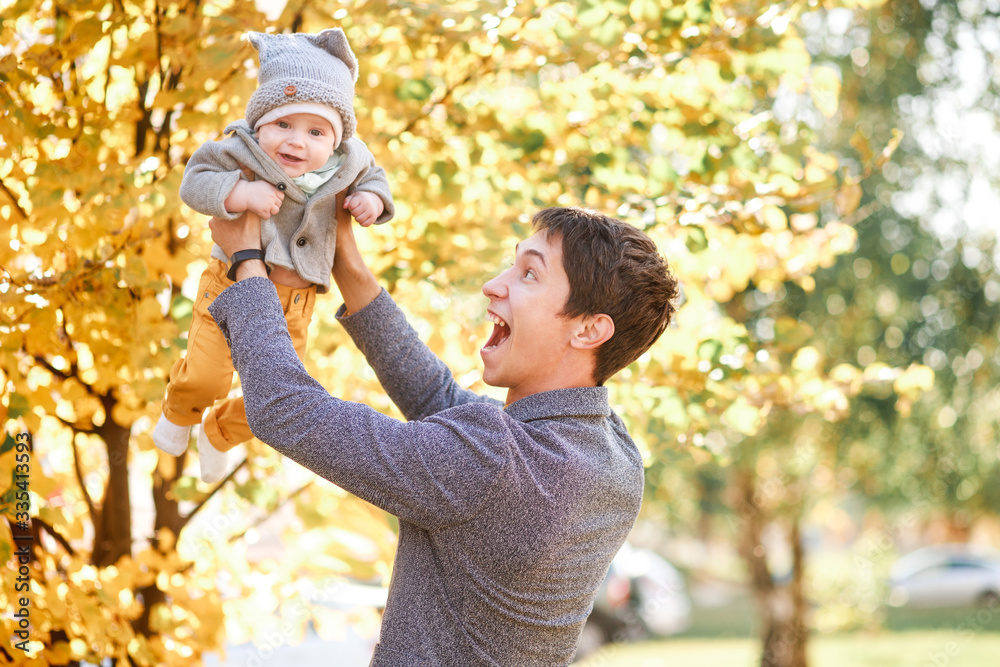a little boy is sitting in his father's arms a little boy is sitting in his father's arms
