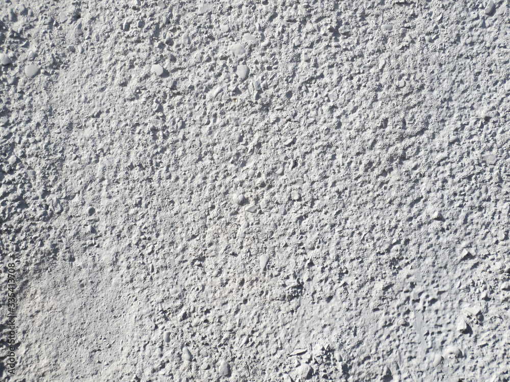 The texture of the grey painted concrete surface.