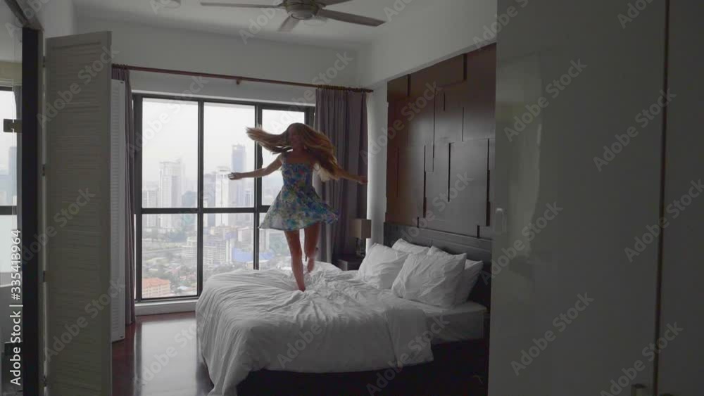 Happy Woman Jumping on the Bed Happy Woman Jumping on the Bed