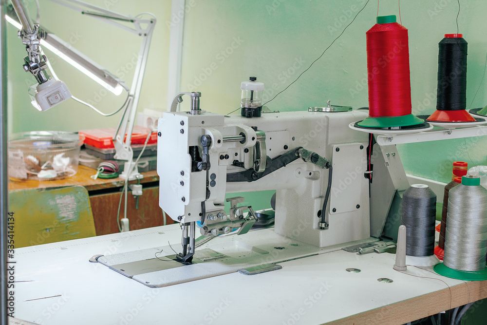professional production sewing machine close-up, leather production, seamstress, tailor