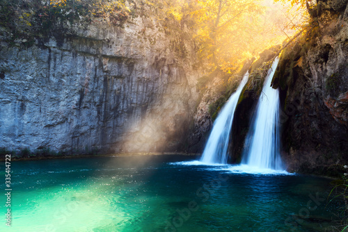 Sunbeams on amazing waterfall in Plitvice lakes. Plitvice National Park, Croatia. Landscape photography