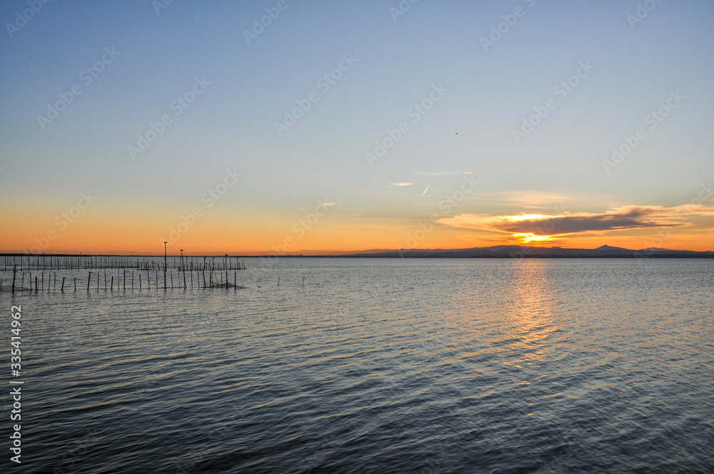 Sunset at pier in the Natural Park of the Albufera in Valencia