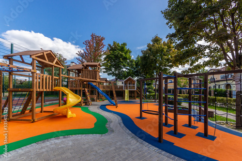 Outdoor play area features toddler children’s play equipment. Colorful playground photo