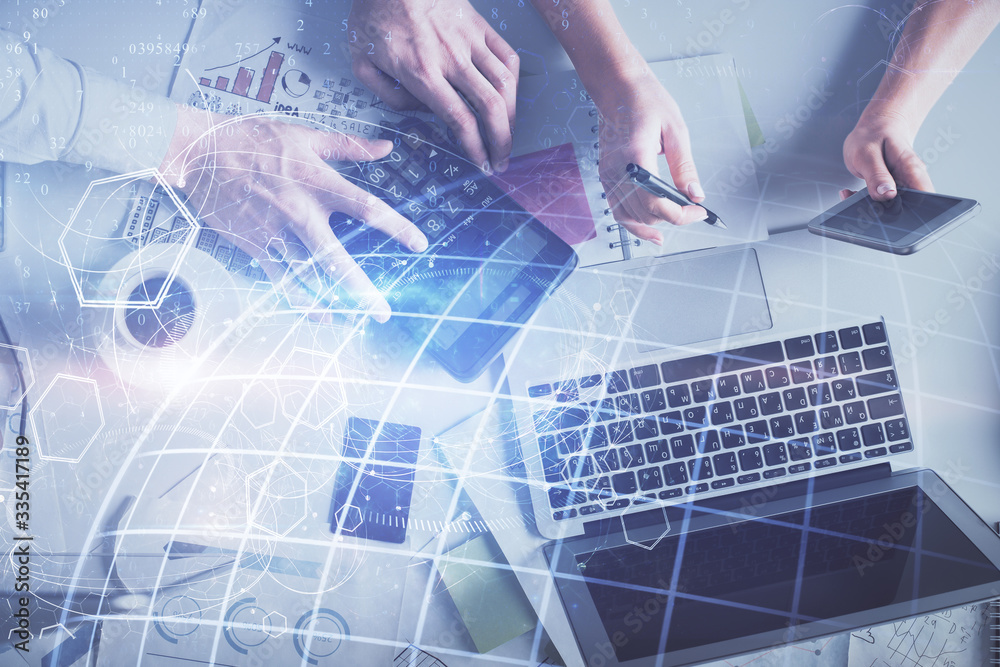 Naklejka premium Double exposure of man and woman working together and world map hologram drawing. international network concept. Computer background. Top View.