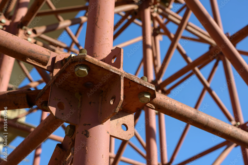Scaffolding Elements Construction. Metal scaffolding tubes and bars. Construction site details. Bridge support. Industrial background. Scaffolding Elements Construction. Metal scaffolding tubes and bars. Construction site details. Bridge support. Industrial background.