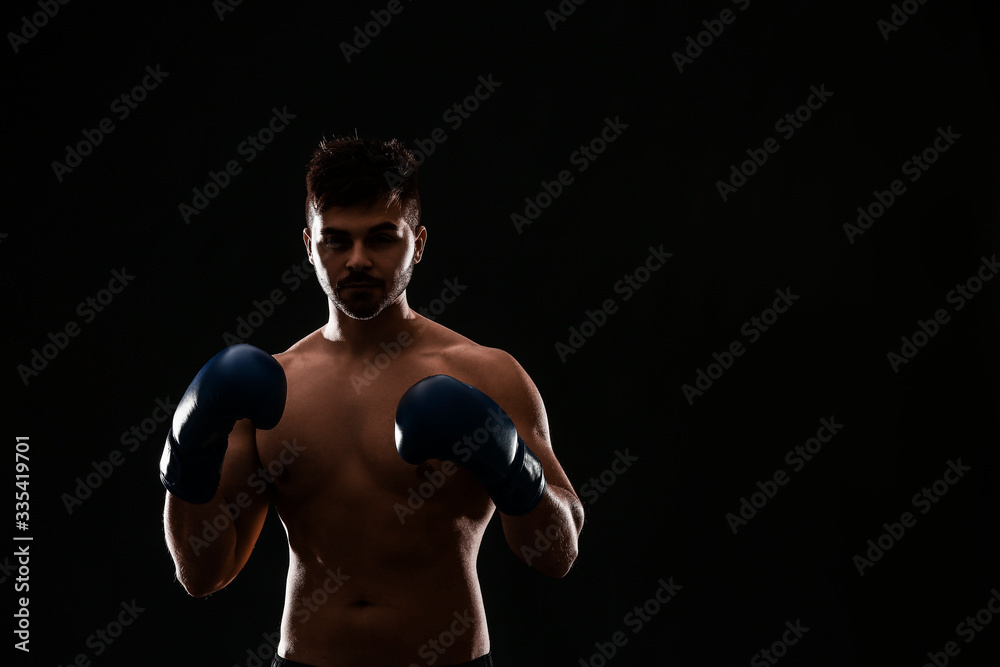 Silhouette of male boxer on dark background