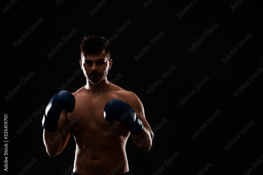 Silhouette of male boxer on dark background Silhouette of male boxer on dark background