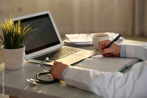 Professional doctor working at table in office  closeup