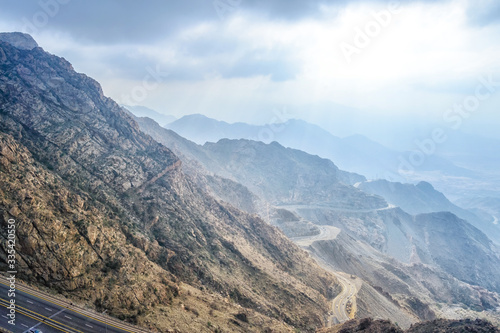 Long exposure of car light trails on a cloudy mountain road at Al Huda, Saudi Arabia