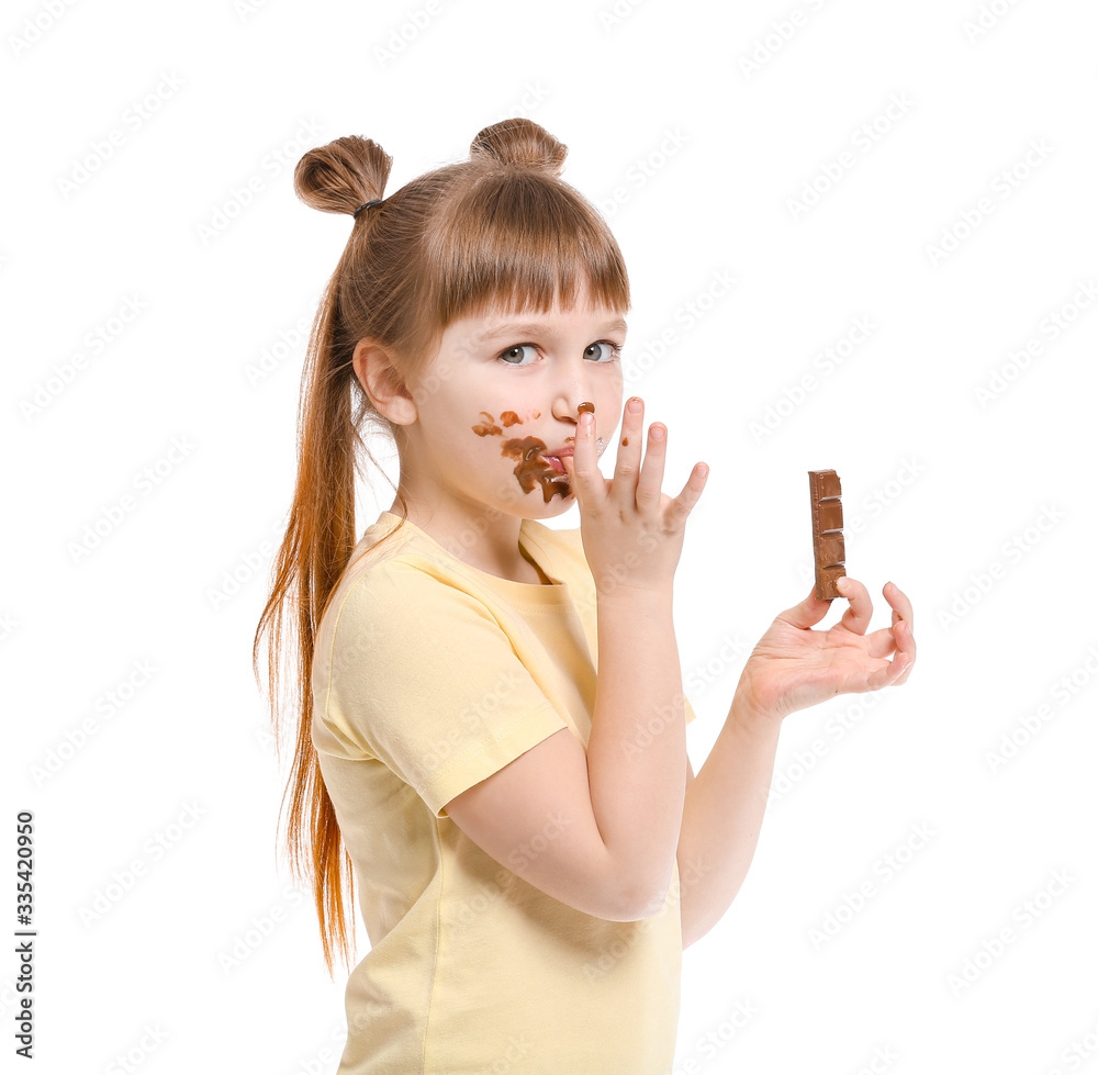 Cute little girl eating chocolate on white background Cute little girl eating chocolate on white background