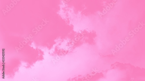 Pastel sky background. Pink sky with fluffy clouds 16:9 panoramic format