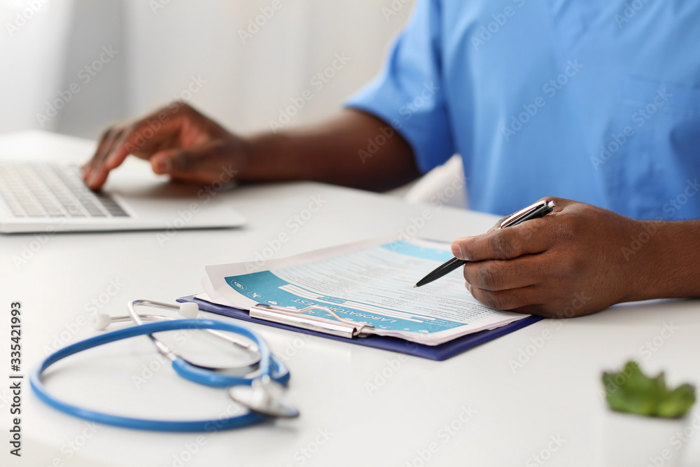 Male African-American doctor working in clinic Male African-American doctor working in clinic