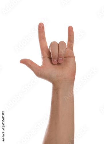 Man showing rock gesture against white background, closeup of hand