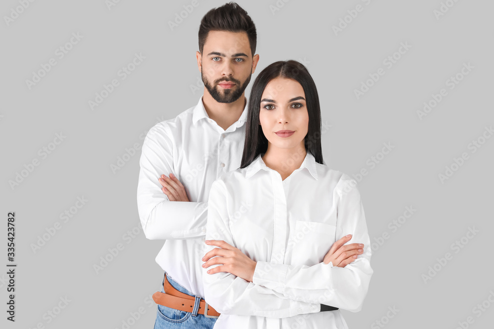 Young couple with beautiful healthy hair on grey background Young couple with beautiful healthy hair on grey background