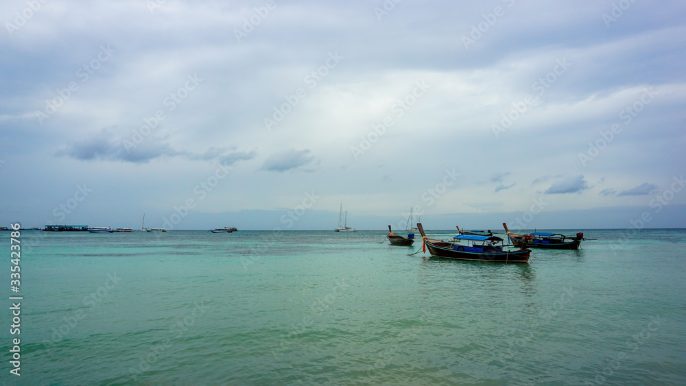 Tourist boat Wooden tradition longe tail boat for transport tourists to island in Andaman Blue sea at Koh Lipe in Satul Province, Thailand. Tourist boat Wooden tradition longe tail boat for transport tourists to island in Andaman Blue sea at Koh Lipe in Satul Province, Thailand.