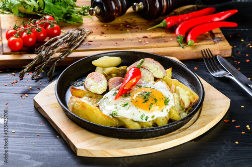 fried eggs and fried potatoes in a pan homemade food