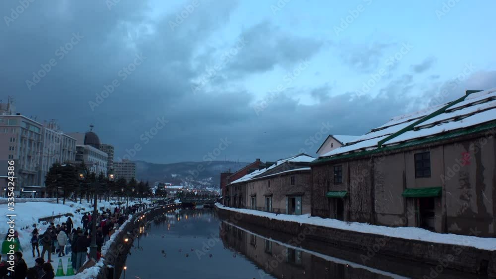 OTARU, HOKKAIDO, JAPAN - FEBRUARY 2020 : Scenery of OTARU CANAL in winter snow season. Popular tourist destination for Japanese and foreign visitors. Time lapse shot sunset to night. OTARU, HOKKAIDO, JAPAN - FEBRUARY 2020 : Scenery of OTARU CANAL in winter snow season. Popular tourist destination for Japanese and foreign visitors. Time lapse shot sunset to night.