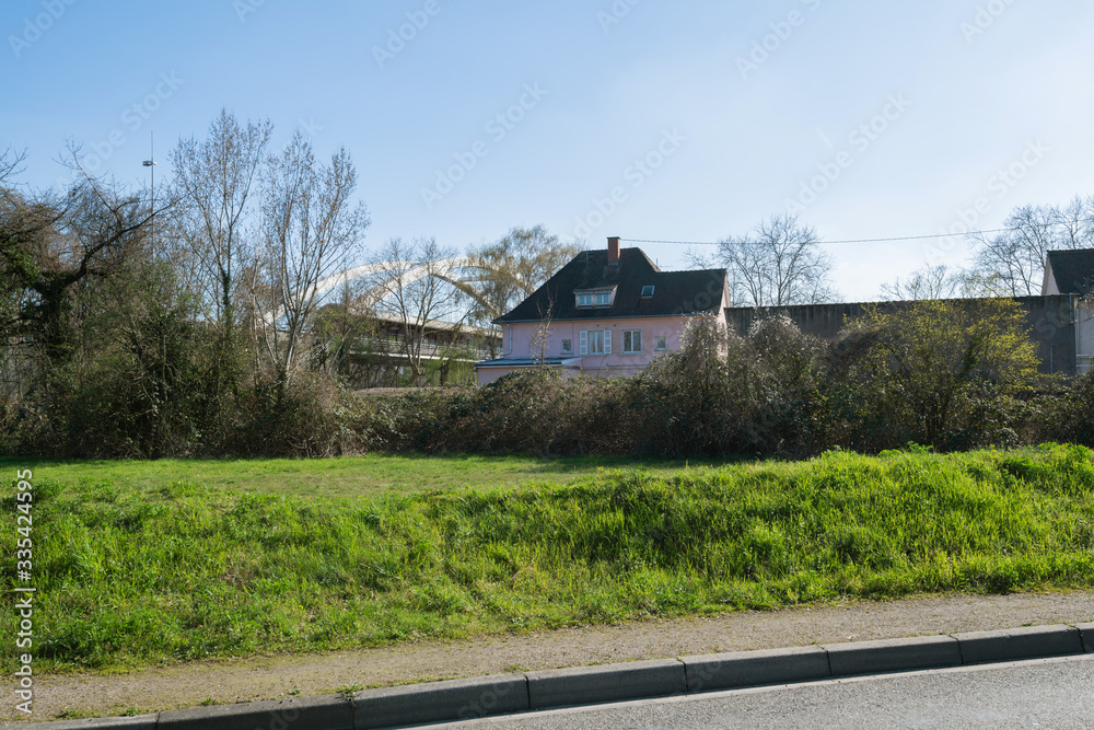 View from the street of generic house in Strasbourg Alsace and bridge in background near the industrial port Robertsau