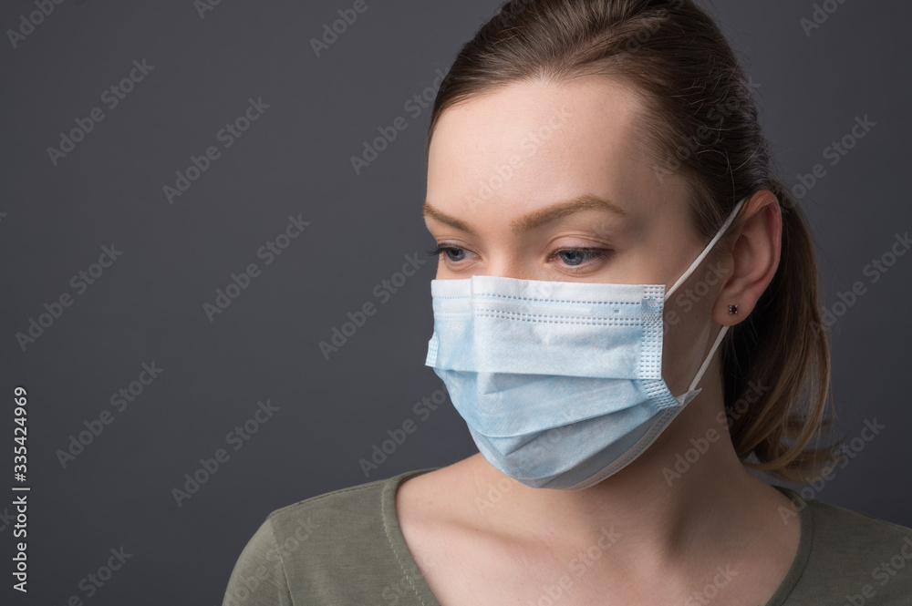 Epidemic and pandemic. Girl in a medical mask on a black background with space for an inscription. Coronavirus Epidemic and pandemic. Girl in a medical mask on a black background with space for an inscription. Coronavirus