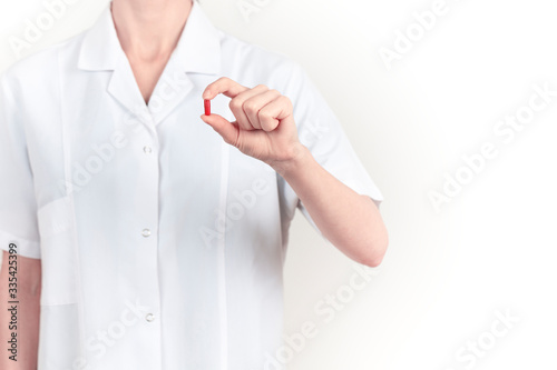 The doctor is holding a medicine in his hand. White background
