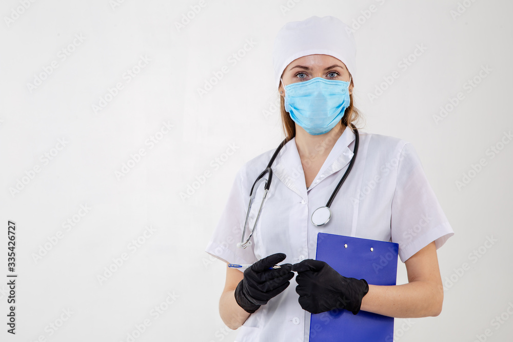 Doctor in a white robe with a stethoscope in his hands. Doctor in a white robe with a stethoscope in his hands.