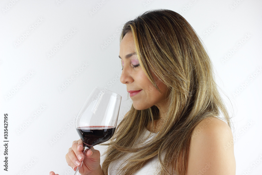 Beautiful Colombian woman smelling her wine Beautiful Colombian woman smelling her wine