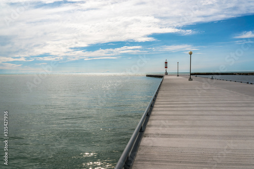 The concrete pier on the sea/ocean with blue sky at dusk. background - copy space