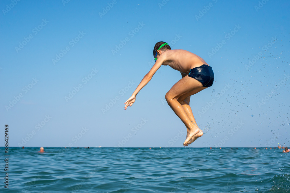 Executing water jumps. Boy flying in midair.