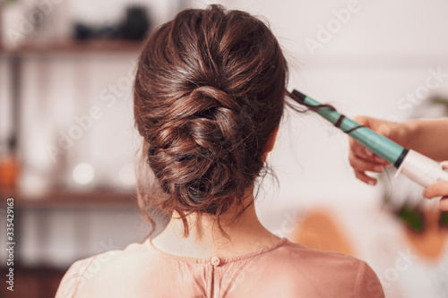 Hairdresser working with yo...