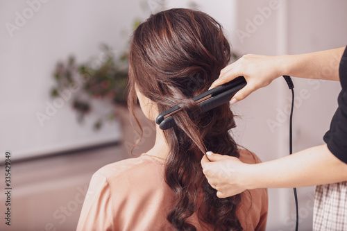 Hairdresser working with yo...