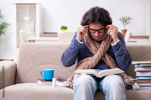 Sick male student suffering at home