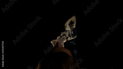 Close-up smoke from shisha hookah comes out mouth man, thick clouds of steam.
