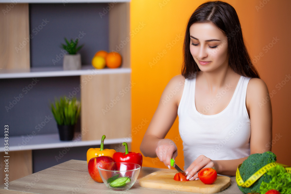 Young beautiful girl prepares a useful diet salad.