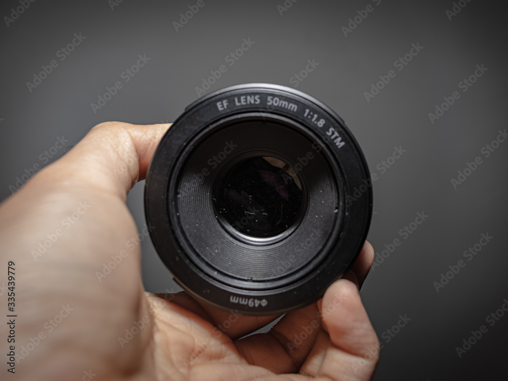 hand holding a camera lens hand holding a camera lens