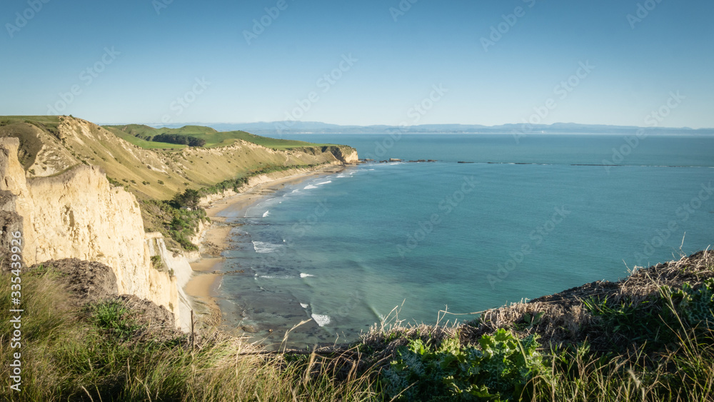 View on a rugged coast with cliffs and turquoise ocean waters. shot made on Cape Kidnappers Trail, New Zealand