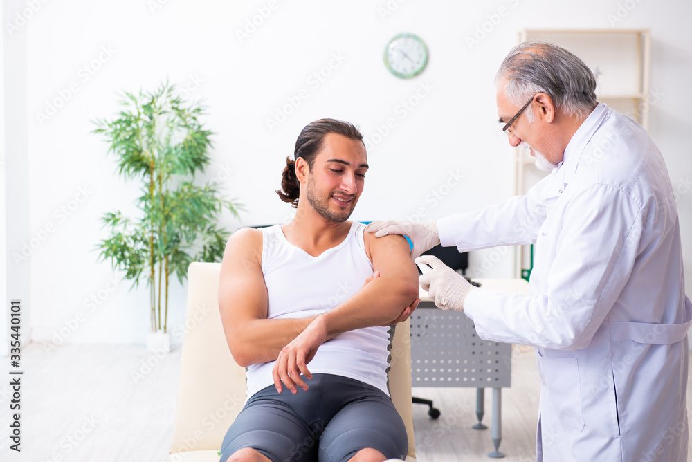 Fototapeta premium Young male patient visiting experienced doctor