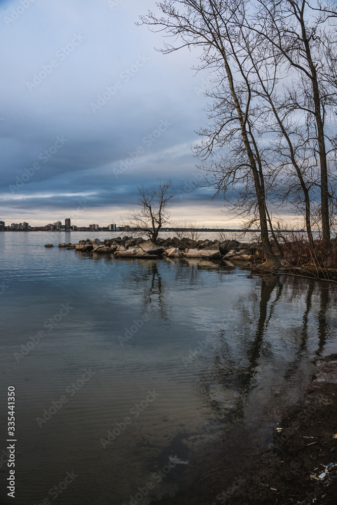 Image of Beachside View of Water during Cloudy Sunset with Reflection for Dark Landscape