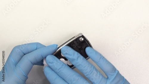 Man Wipes Clean Car Keys With Sanitizing Wipe Wearing Gloves 4K photo