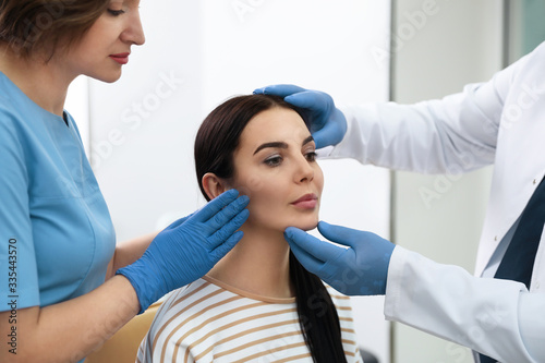 Professional doctors examining patient before surgery in clinic