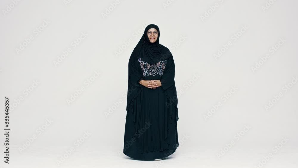 Full length of a smiling muslim woman in hijab on white background. Happy Arabic woman wearing eyeglasses looking at camera.
Full length of a smiling muslim woman in hijab on white background. Happy Arabic woman wearing eyeglasses looking at camera.