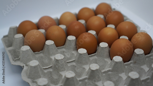 Some eggs lay on top of the egg carton photo