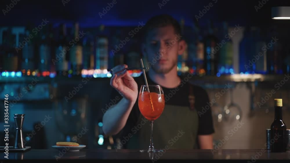 bartender mixing aperol spritz cocktail in night club bartender mixing aperol spritz cocktail in night club