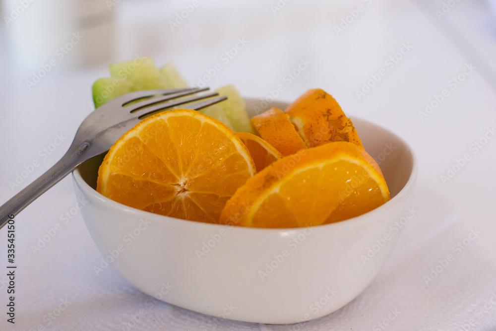 Close up of some Delicious fresh oranges and fruit in a white bowl Close up of some Delicious fresh oranges and fruit in a white bowl