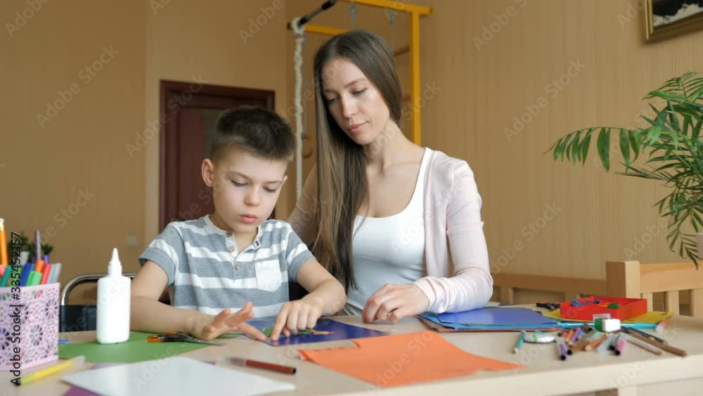 Home schooling. Mother and son doing art supplies homework Home schooling. Mother and son doing art supplies homework