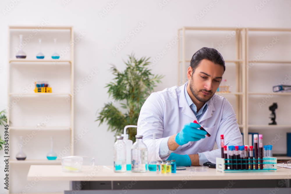 Young male chemist working in the lab Young male chemist working in the lab